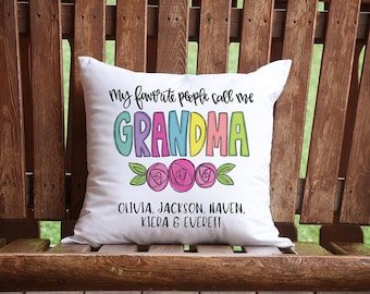 May include: White throw pillow with the text "My favorite people call me GRANDMA" in colorful letters with flowers. The names Olivia, Jackson, Haven, Kiera & Everett are listed below.