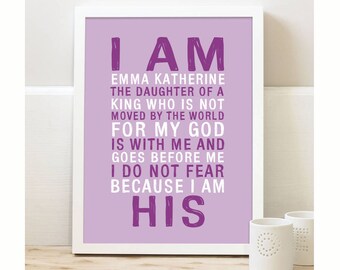 May include: Purple and white framed print with the text "I AM EMMA KATHERINE THE DAUGHTER OF A KING WHO IS NOT MOVED BY THE WORLD FOR MY GOD IS WITH ME AND GOES BEFORE ME I DO NOT FEAR BECAUSE I AM HIS"