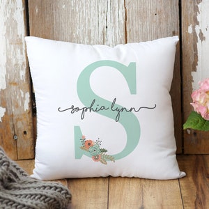 May include: White pillow with a light green letter "S" and floral design. The text "sophia lynn" is written in cursive above the letter.