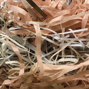 Op de afbeelding: Een close-up van gescheurd papier in tinten bruin, beige en wit. Het papier is verward en overlapt, waardoor een textuurrijke achtergrond ontstaat.