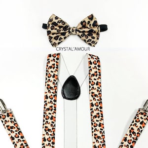 May include: A set of suspenders and a bow tie with a leopard print pattern. The suspenders are adjustable and have a clip-on design. The bow tie is pre-tied and has a satin finish.
