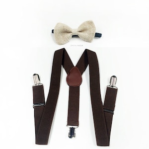 May include: Brown suspenders with adjustable clips and a brown leather detail. A beige bow tie is also included.