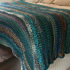 Crochet comforter in teal, mustard, purple, magenta and grey