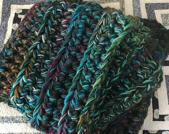 Crochet blanket in teal, blue, green, magenta and grey