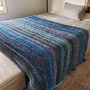 Crochet bedspread in blues grays and teals