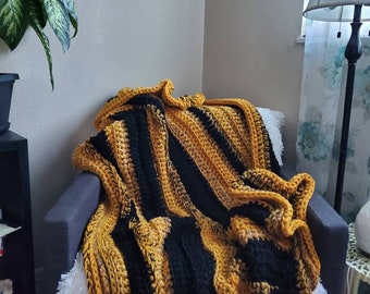 Crochet blanket in black, mustard and gray stripes