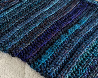 Crochet throw blanket in blues and purple jewel tones