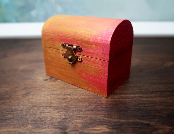 A cute pink hand painted wooden box with lid