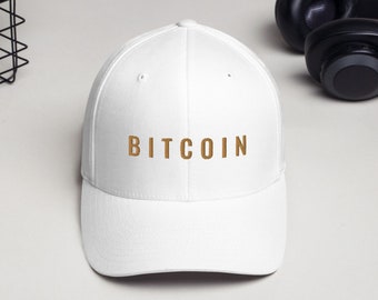 May include: White baseball cap with a gold embroidered "BITCOIN" logo.