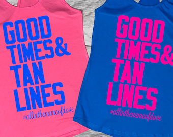 May include: A pink tank top with blue text reading GOOD TIMES & TAN LINES and #allinthenameofdove, and a blue tank top with pink text reading GOOD TIMES & TAN LINES and #allinthenameofdove. Both feature a racerback style design.