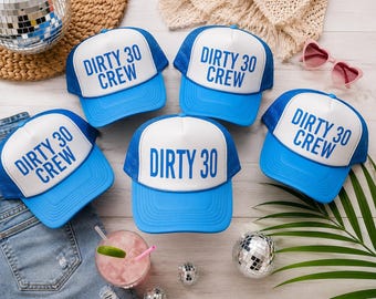 May include: Five blue and white trucker hats featuring white front panels with blue text. Four hats display the text DIRTY 30 CREW, while one hat displays the text DIRTY 30. The hats have blue mesh backs, blue brims, and blue adjustable snap closures.