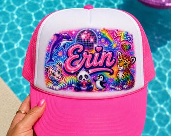 May include: A bright pink and white trucker hat featuring a colorful Lisa Frank graphic print. The design includes the name Erin in large pink letters, a purple dolphin, a rainbow tiger, a panda, a penguin, a leopard, and a disco ball.