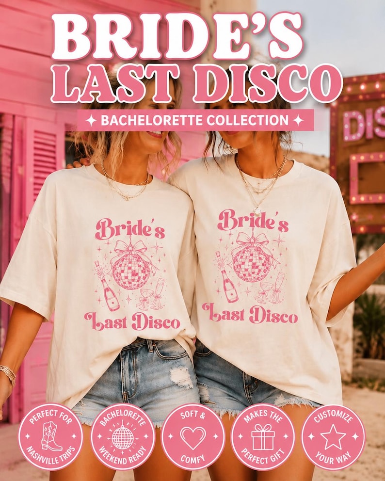 May include: Two off-white t-shirts featuring a pink graphic print of a disco ball with a bow, a champagne bottle, and two glasses. The text reads "Bride's Last Disco". The design includes small star accents. The shirts have short sleeves.