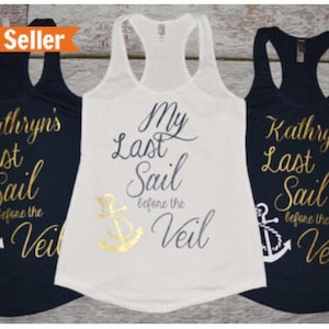 May include: Three tank tops with gold lettering and an anchor graphic. The text on the white tank top reads "My Last Sail Before the Veil". The text on the two navy blue tank tops reads "Kathryn's Last Sail Before the Veil".