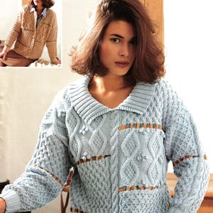 May include: A woman models a light blue Aran-style knitted sweater with a shawl collar and cable patterns. The sweater features orange and brown detailing. The image also includes a smaller image of a similar tan-colored sweater. Measurements: 81/86-102/107cm (32/34-40/42ins).
