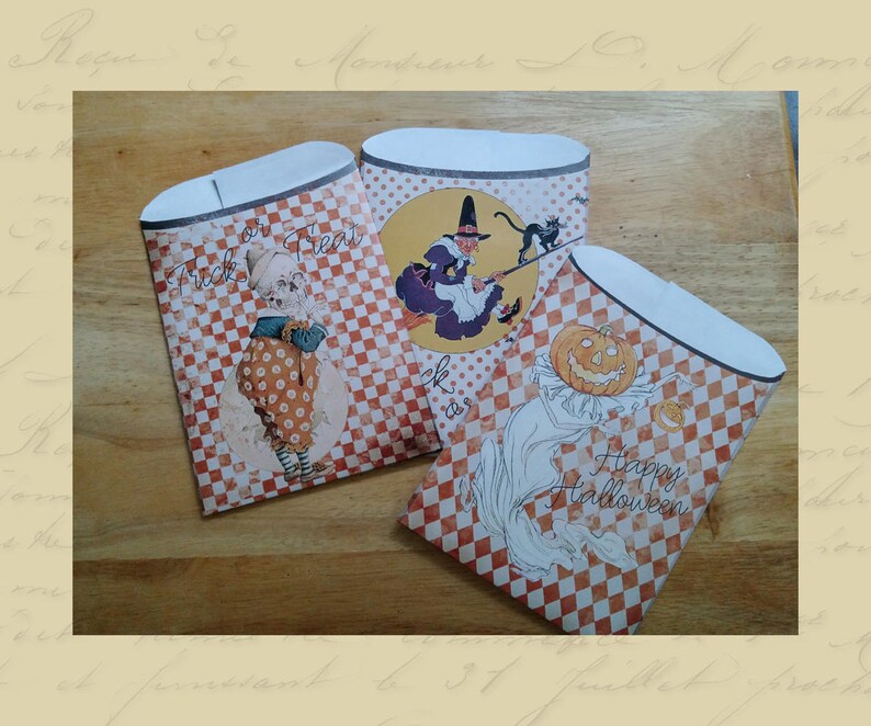 May include: Three orange and white checkered paper treat bags with Halloween themes. One bag features a witch flying on a broomstick with a black cat, another bag features a girl in a dress holding a pumpkin, and the third bag features a ghost with the text "Happy Halloween".