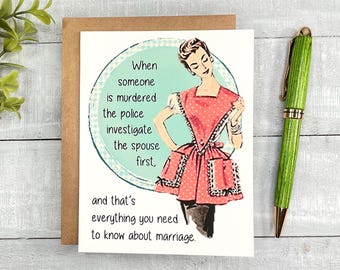 May include: A humorous greeting card with a retro illustration of a woman in a pink and white polka dot dress and apron. The text reads: "When someone is murdered the police investigate the spouse first, and that's everything you need to know about marriage."