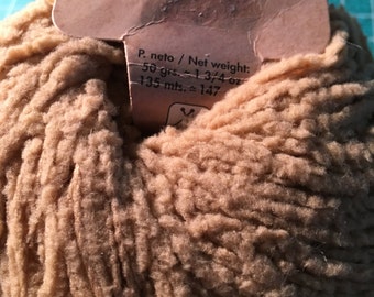 May include: A ball of Katia Mousse yarn in a light brown colour. The label reads "Katia Mousse" and "P. neto / Net weight: 50 grs. = 1-3/4 oz 135 mts. = 147"