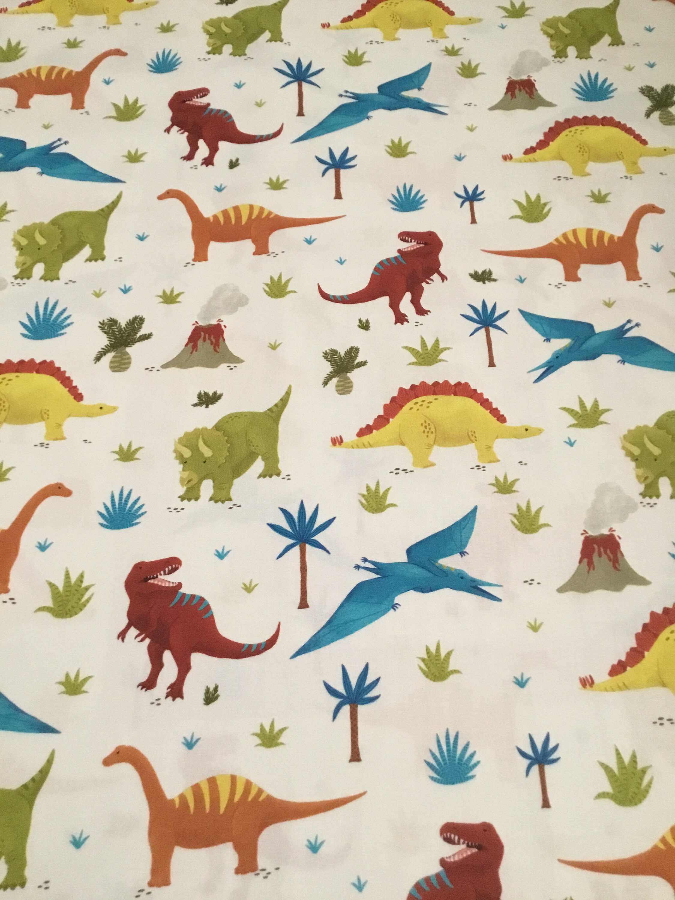 Robert Kaufman Fabrics - PREHISTORIC ADVENTURE - 100% Premium Cotton Fabric multi colored dinosaurs on white background 1/2 yd
