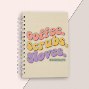 May include: A cream-colored spiral notebook with the words "coffee, scrubs, gloves" in colorful, rounded letters. The text "#NURSELIFE" is written in a smaller font below the main text.