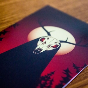 May include: A dark red and black card featuring a white skull with red eyes and antlers. The skull is positioned in front of a white moon against a red backdrop. The card has a dark forest silhouette in the background.