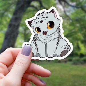 May include: A sticker of a cute, cartoon, gray and white owl with black eyes and a black beak. The owl is sitting on its haunches with its wings folded.