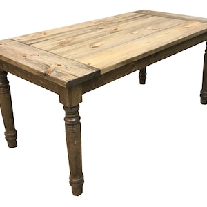 May include: A rustic wooden table with a natural wood finish and turned legs. The table has a rectangular top and is made of solid wood.