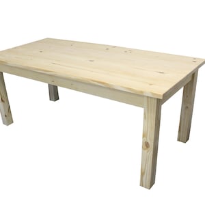 May include: A simple, rectangular wooden table with four legs. The table is made of unfinished pine wood and has a natural wood color.