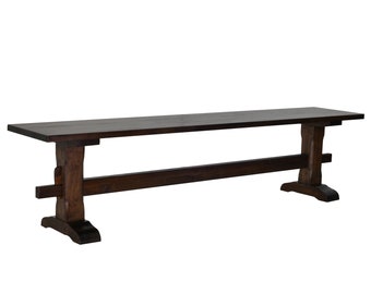 May include: A dark brown wooden bench with a simple, rectangular design. The bench has a sturdy, solid construction with a wide, flat seat and two sets of legs that are connected by a horizontal support beam.