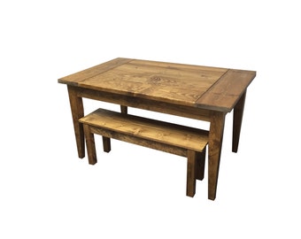 May include: A rustic wooden table and bench set. The table is made of reclaimed wood and has a natural finish. The bench is also made of reclaimed wood and has a natural finish. The table and bench are both in a farmhouse style.