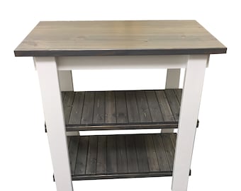 May include: A white kitchen island with a gray wood top and two shelves. The shelves are made of gray wood planks.