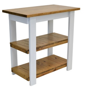 May include: White kitchen island with a wood top and two shelves. The shelves are made of reclaimed wood.