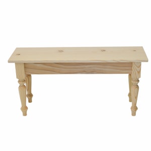 May include: A natural wood bench with a simple design. The bench has a rectangular top and four turned legs.