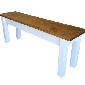 May include: A wooden bench with a white painted base and a natural wood top. The bench has a simple, farmhouse style.