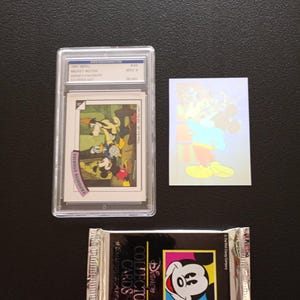 1991 Impel Disney Collector Cards LOT of one Mickey Hologram, one Graded Collector Card Mint 9, one sealed pack of Disney Collector Cards.