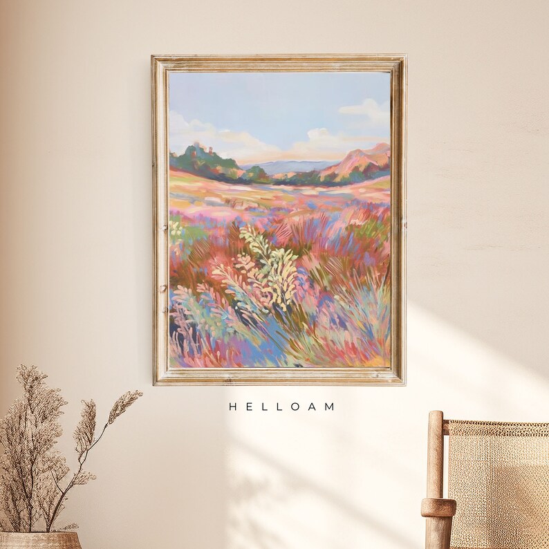 May include: A framed painting of a landscape with a field of colorful wildflowers in the foreground and rolling hills in the background. The sky is a light blue with a few clouds. The painting is in a gold frame and has the text "HELLOAM" printed below it.