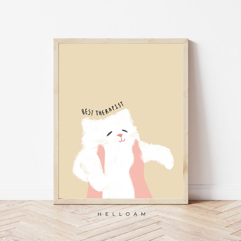 May include: A beige background with a white cat with pink hands on either side of its face. The text "BEST THERAPIST" is above the cat. The text "HELLOAM" is below the cat.