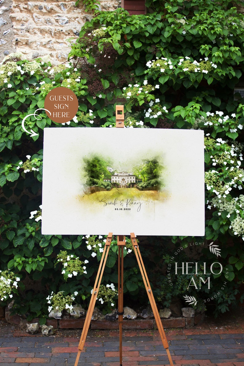 May include: A white sign with a watercolor illustration of a house and the text "Sarah & Kenny 03.10.2022" on an easel in front of a green bush with white flowers.