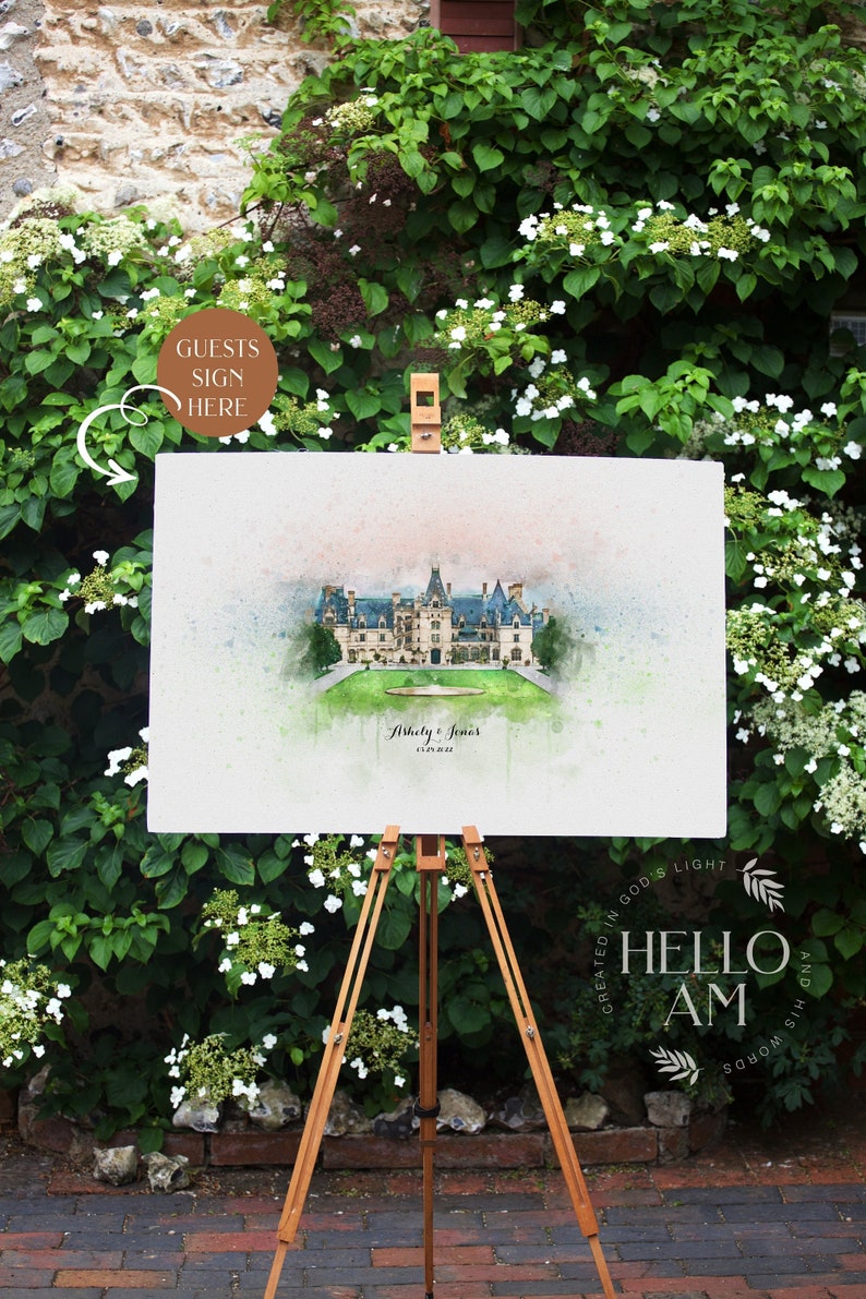 May include: A watercolor painting of a large white house with a green lawn in front of it. The painting is on a canvas and is propped up on an easel. The text "Guests Sign Here" is written on a brown circle in the upper left corner of the image. The text "Ashley & James 6.18.2022" is written below the house. The text "Created in God's Light Hello AM And His Words" is written in a circle in the lower right corner of the image.