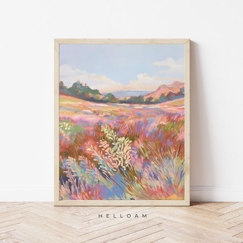 May include: A painting of a field of wildflowers in shades of pink, purple, blue, and green. The field is in the foreground, with a distant landscape of hills and trees in the background. The sky is a light blue with a few clouds.