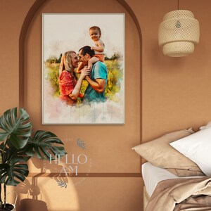 May include: A watercolor painting of a family of three in a field. The father is holding the child on his shoulders, and the mother is standing next to them. The painting is framed in a white frame and hanging on a wall.