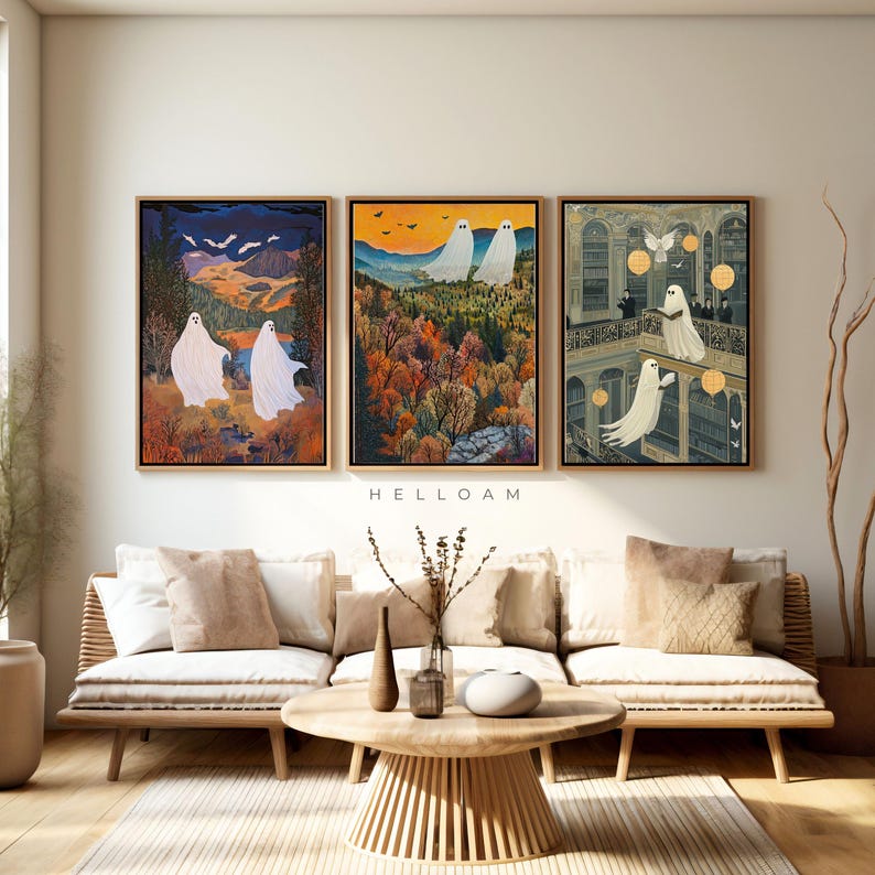 May include: Three framed art prints featuring white ghosts in different settings. The first print shows two ghosts walking through a forest, the second shows a ghost flying over a forest, and the third shows a ghost reading a book in a library.