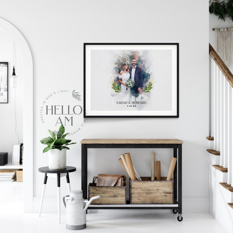 May include: A black framed watercolor painting of a wedding couple standing in front of a watercolor background with green foliage. The text "SARAH & HOWARD 3.10.20" is printed below the couple.