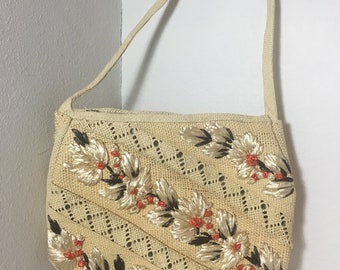 Bolsa vintage de palha e ráfia, com apliques florais, ideal para o verão.