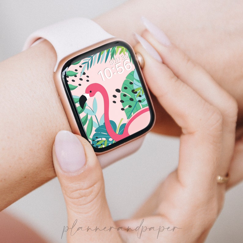 May include: A pink and white Apple Watch with a tropical-themed watch face featuring a pink flamingo, green leaves, and black dots. The watch face also displays the time, "10:56", and the day, "Sun 30".