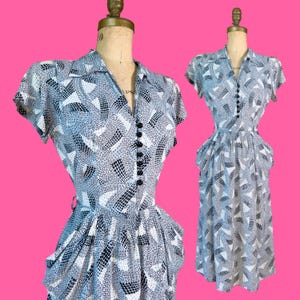 vintage 1940s dress // busy abstract print cold rayon 40s day dress // draped hip shelf pockets + padded shoulders // 27&quot; waist