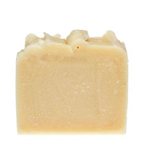 May include: A bar of off-white soap with a slightly rough texture.