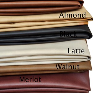 May include: A stack of seven different coloured leather swatches. The swatches are labelled from top to bottom: Pecan, Almond, Black, Latte, Walnut, Merlot, and Cacao.