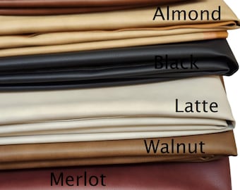 May include: A stack of seven different colored leather swatches. The swatches are labeled from top to bottom: Pecan, Almond, Black, Latte, Walnut, Merlot, and Cacao.