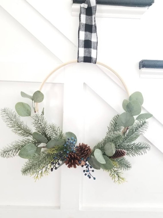 Silver White Winters Hoop Wreath with eucalyptus, silver pine, and berries in blue